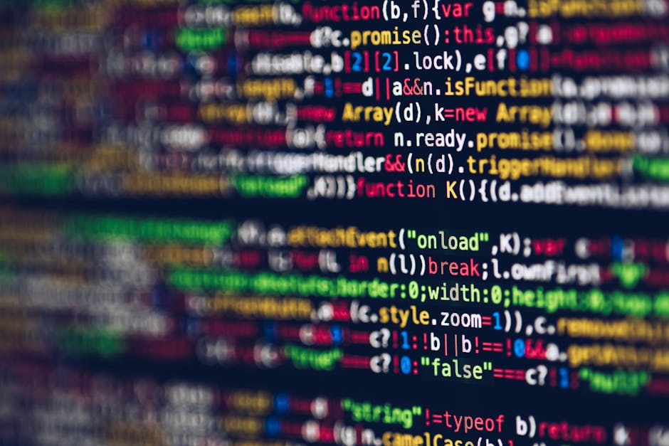 Close-up photograph of a computer screen displaying a code editor with syntax-highlighted programming code. The left side of the screen shows a light-colored directory tree with folder names such as '